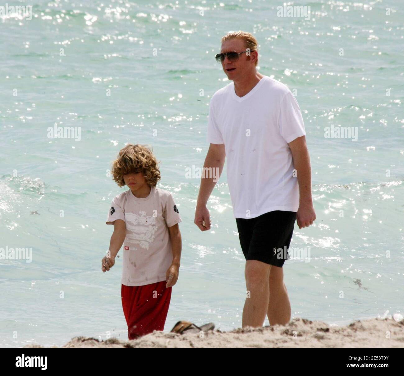 Exclusif !! Boris Becker prend son fils Elias pour une promenade dans le surf. Elias a fait des bombes de sable et les a jetées dans l'océan tandis que papa a tenu son jouet mignon lion, Miami Beach, FL. 10/19/07. [[balise mab]] Banque D'Images