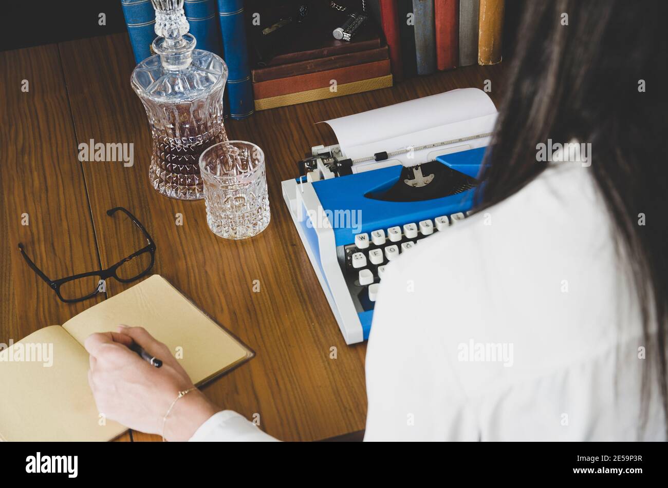 Photo d'époque de vieux livres. La main de l'écrivain est sur la machine à écrire .Writer écrivant un roman d'amour. Romancier écrivant un roman sur une machine à écrire Banque D'Images