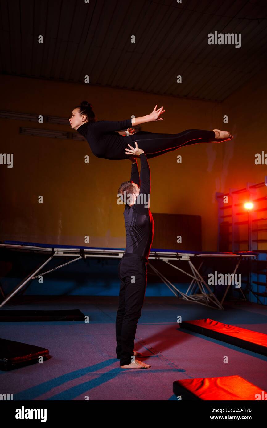 Un duo d'acrobates effectuant un double tour. Une femme en combinaison de  gymnastique et un homme en vêtements de sport. Artistes de cirque très  flexibles Photo Stock - Alamy