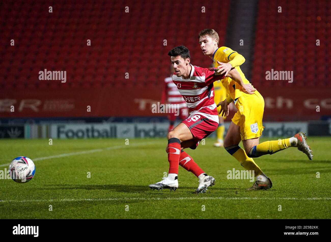 Ed Williams de Doncaster Rovers (à gauche) et Daniel Csoka de l'AFC Wimbledon se battent pour le ballon lors du match de la Sky Bet League One au Keepmoat Stadium, Doncaster. Date de la photo: Mardi 26 janvier 2021. Banque D'Images
