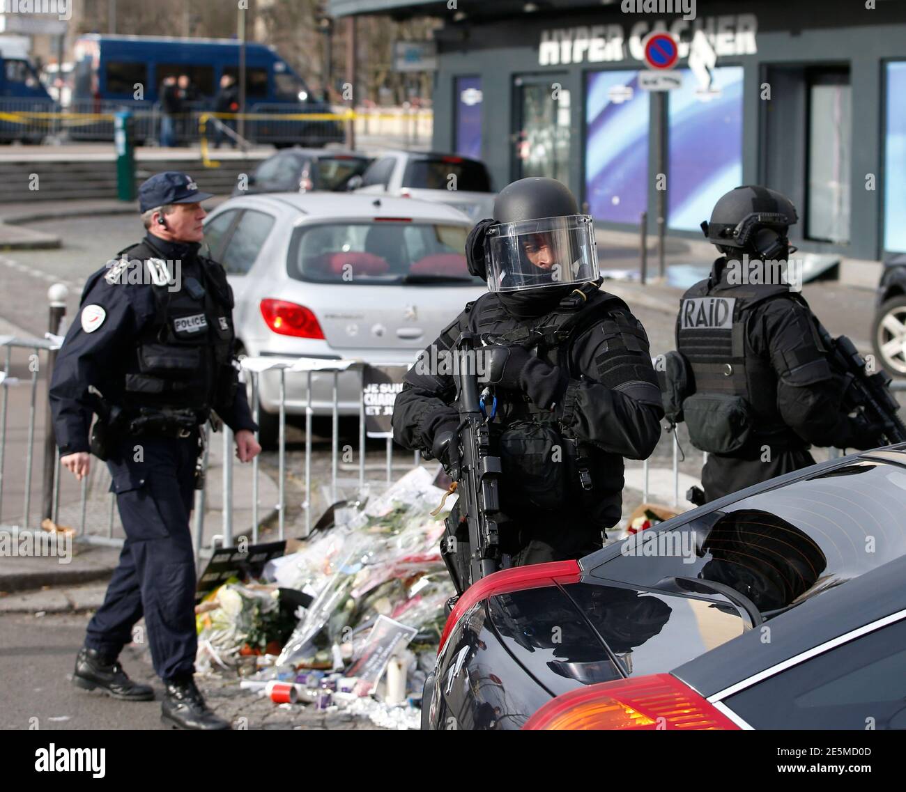 Members of the special French RAID forces secure the area for the visit by  Israel's Prime Minister Benjamin Netanyahu to the Hyper Cacher kosher  supermarket January 12, 2015 near the Porte de