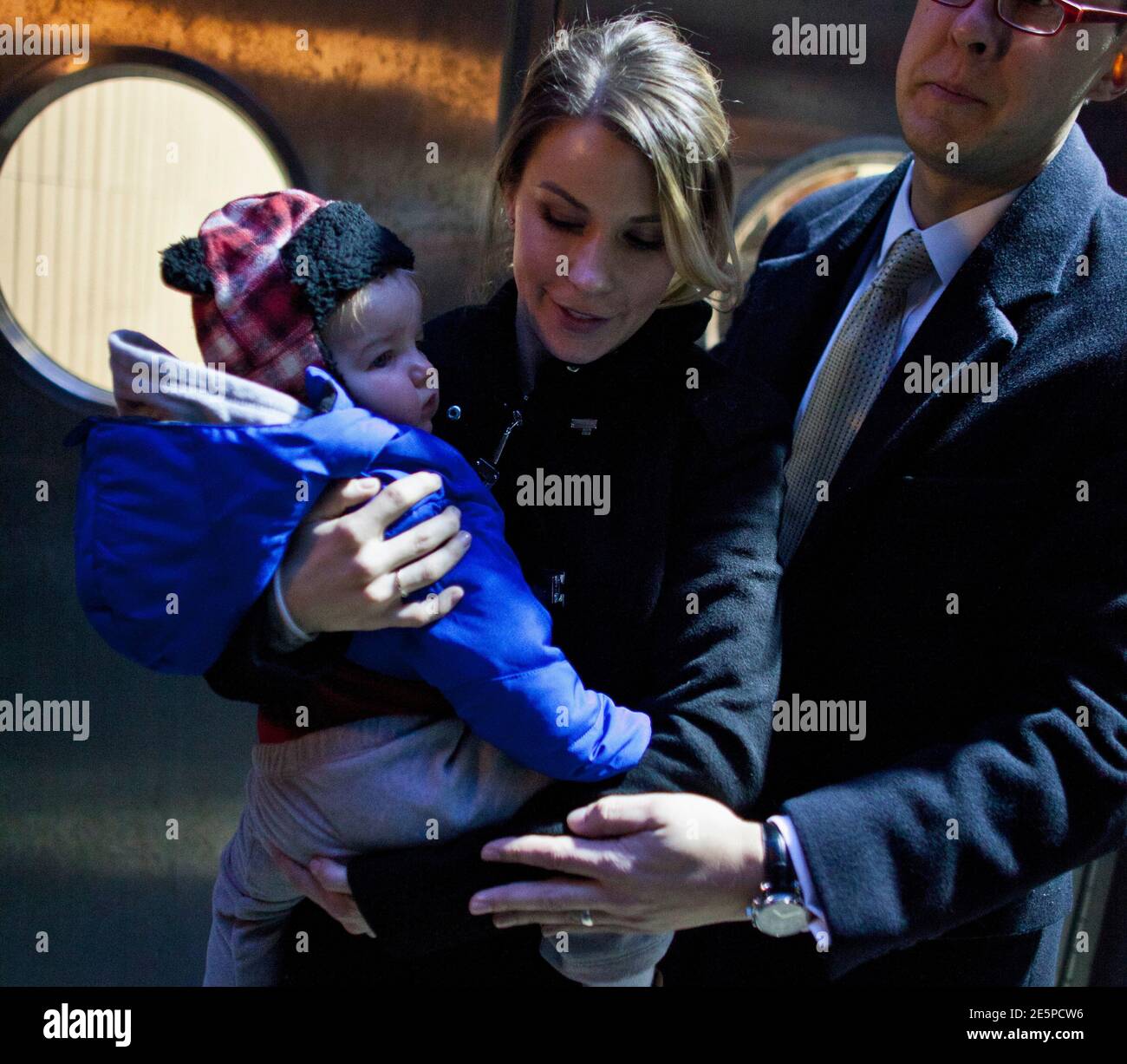 Sara McKenna, former Marine who was briefly involved with Olympic alpine  skier Bode Miller, carries her son while they leave Manhattan's Family  Court in New York, November 25, 2013. The nine-month-old boy