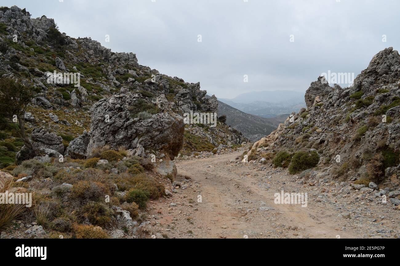 Paysage rocheux scène en Crète, Grèce avec route de terre en passant par les montagnes Banque D'Images