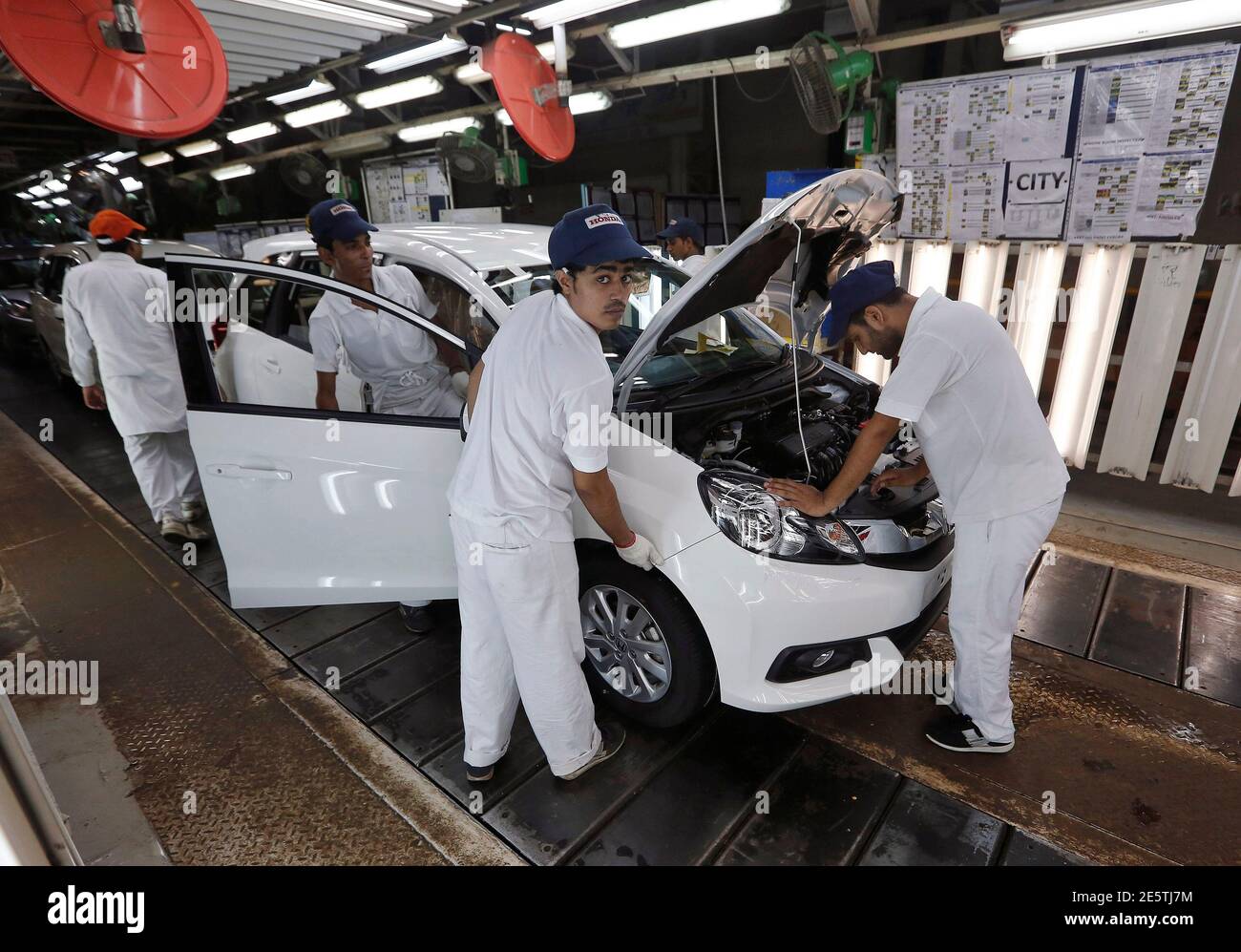 Employees work at the production line on a Honda Mobilio car at a Honda  plant in Greater Noida on the outskirts of New Delhi July 21, 2014. Honda  Motor Co is looking