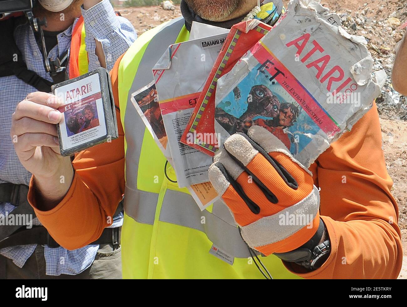 A worker shows the media the first recovered "E.T. the Extra-Terrestrial"  cartridge at the old Alamogordo landfill in Alamogordo, New Mexico, April  26, 2014. Documentary filmmakers digging in a New Mexico landfill