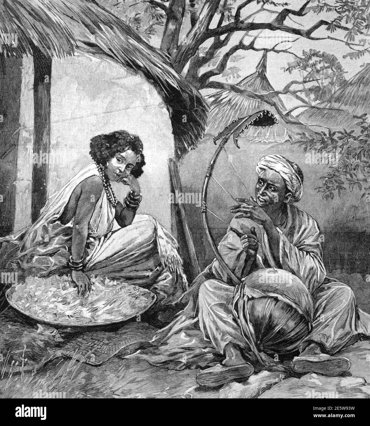 Griot ou West African Storyteller, Bard, historien, louange chanteur ou musicien jouant à cordes Gourd dans African Village 1904 Vintage Illustration ou gravure Banque D'Images