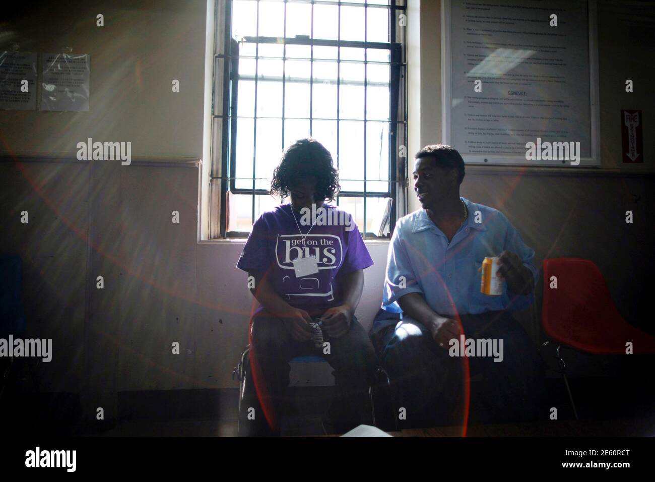 Dejane (L), 14, sits with her father Jonathan at San Quentin state prison  in San Quentin, California June 8, 2012. An annual Fathers' Day event, "Get  On The Bus" brings children in