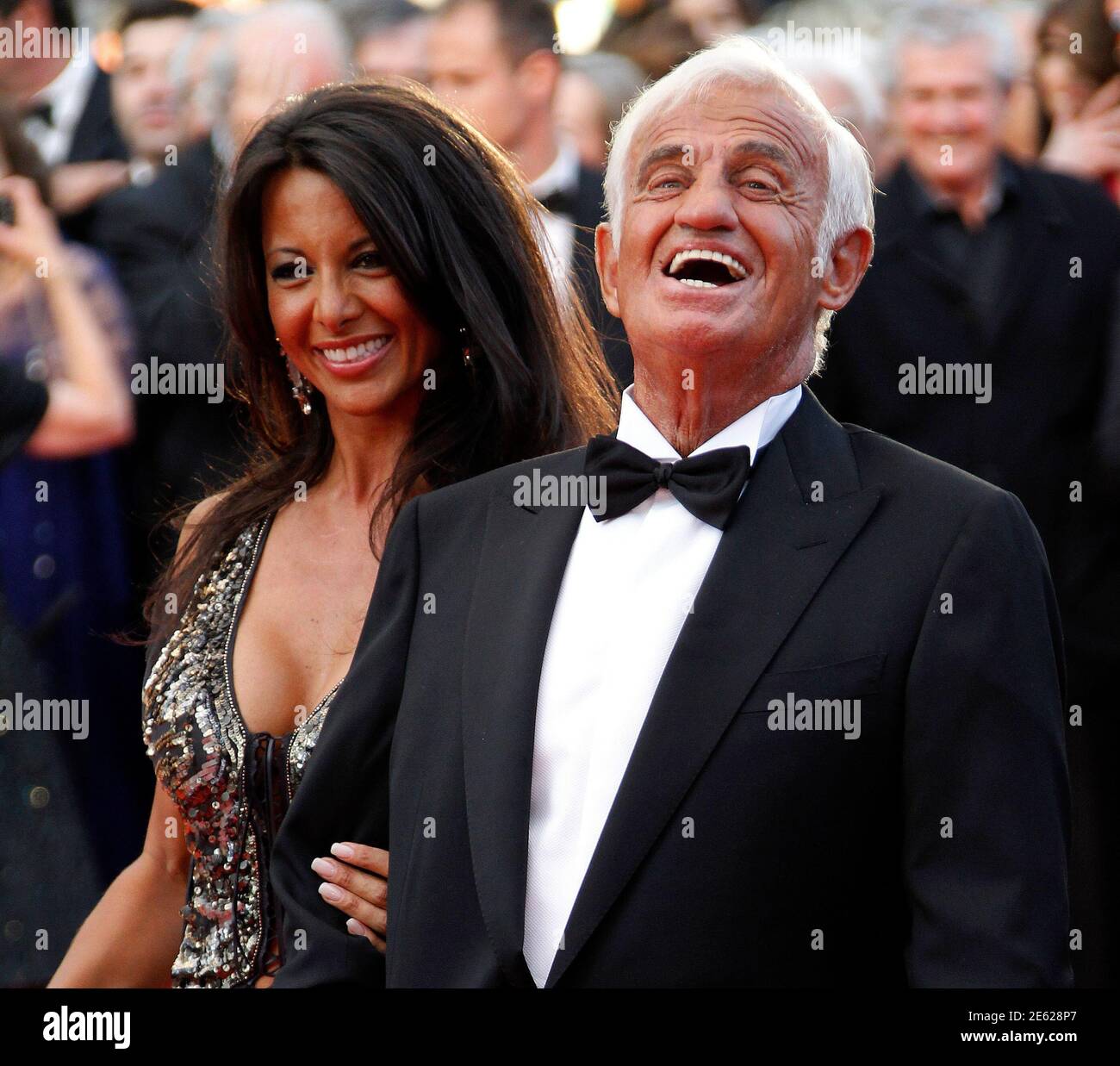 Actor Jean-Paul Belmondo and his partner Barbara Gandolfi arrive on the red  carpet for the screening of a documentary on Belmondo's career at the 64th  Cannes Film Festival, May 17, 2011. REUTERS/Yves