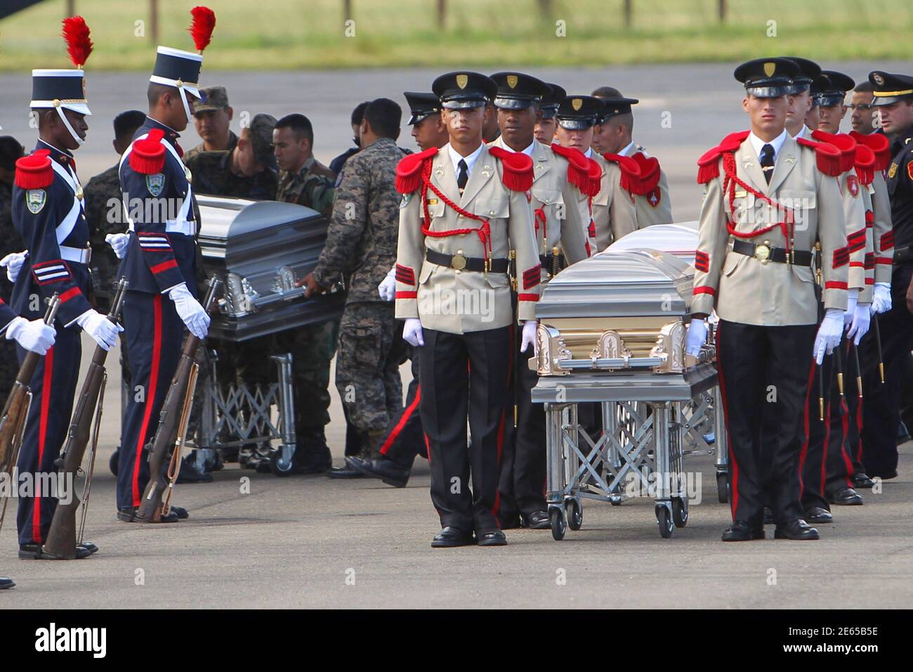Soldiers carry the coffins of two of the Hondurans identified among the 72  illegal immigrants murdered on August 24, 2010 in Tamaulipas, Mexico,  during an official ceremony in Tegucigalpa November 5, 2010.