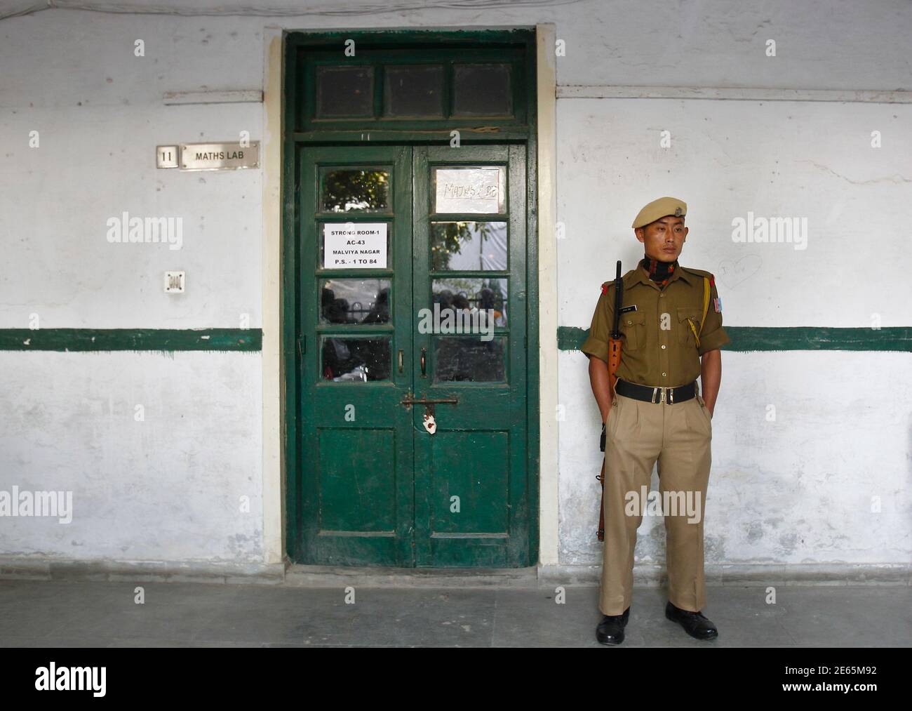 An Indian Security Personnel Stands Guard Outside The Sealed Room Containing Electronic Voting Machines Evm On The Eve Of The State Election In New Delhi December 3 13 Delhi S 12 Million Or