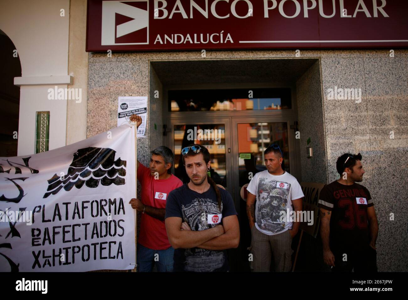 Pablo Siles C 30 And His Brothers R And 2nd R Wait To Talk To An Employee Outside A Banco Popular Bank Branch To Request A Meeting To Try To Stop Their