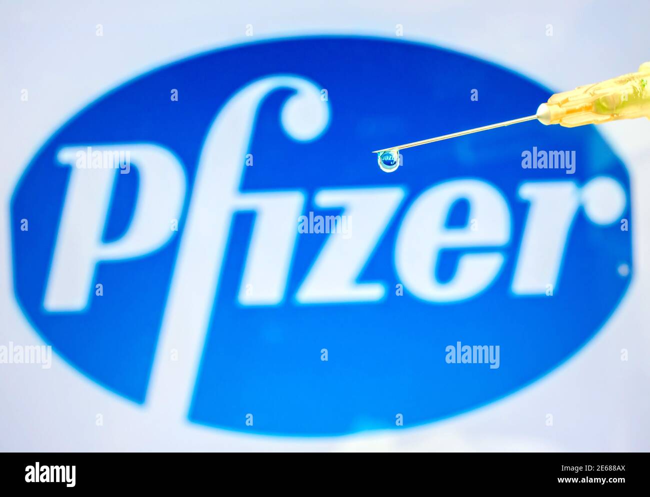 Vienne Autriche janvier 28 2021, seringue avec goutte de liquide contre le logo Pfizer un vaccin contre le coronavirus de la société pharmaceutique multinationale américaine Banque D'Images