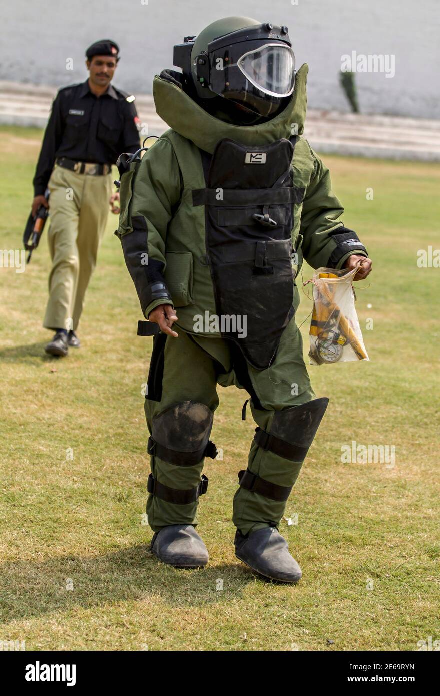 A technician from Pakistan's top bomb disposal unit walks after a  demonstration at the unit's headquarters in Peshawar September 12, 2013.  Twelve years into the war on militancy, Pakistan's police are chronically