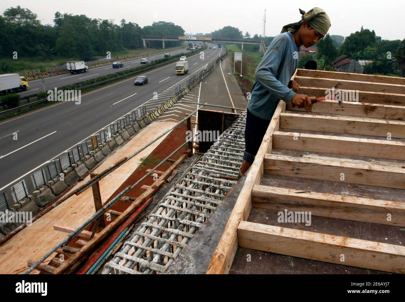 A worker constructs a new toll road by PT Jasa Marga in Cibubur, on the  outskirts