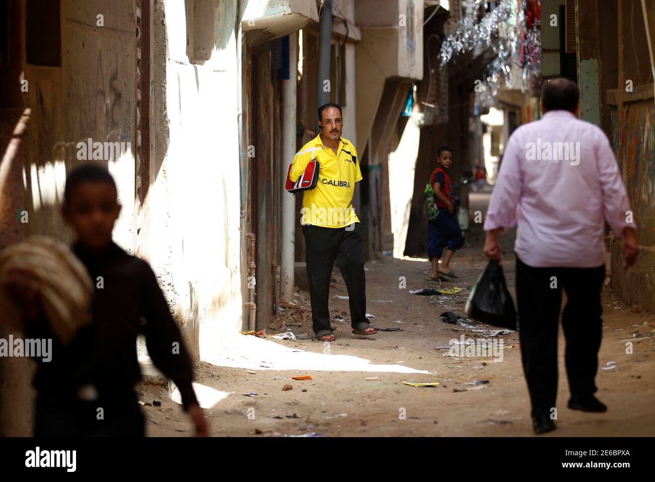 Disabled table tennis champion Ibrahim Hamato, 37, leaves his house in  Domiat, northeast of Cairo, September 28, 2014. Having lost both his arms  in an accident when he was 10, the Egyptian