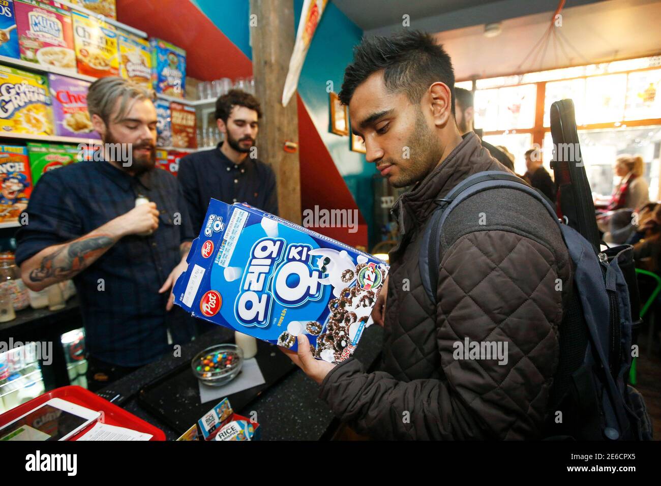 A customer inspects a box of imported cereal at the "Cereal Killer Cafe" in  east London December 10, 2014. Identical twin brothers hope they have  ticked the right boxes, and ordered in