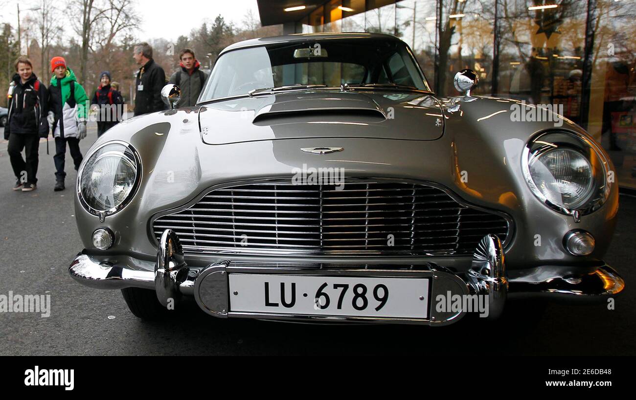 School children walk past the 1964 Aston Martin DB5 made famous in the  James Bond movies "Goldfinger" and "Thunderball" which featured Scottish  actor Sean Connery, as it is displayed for the first