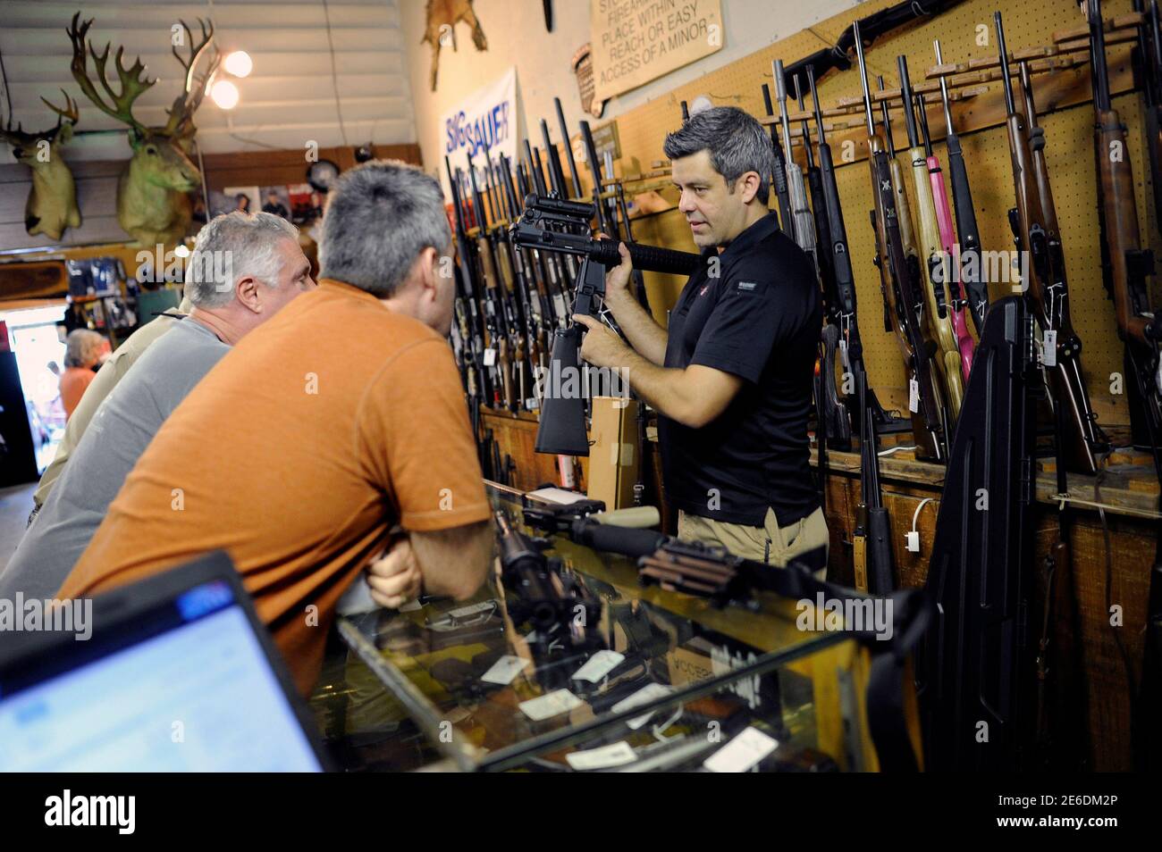 Gun Shop Owner Brooke Misantone R Shows His Last Two Ar 15 Style Rifles To A Group Of Customers As Gun Enthusiasts Start To Crowd Into The Bullet Hole Gun Shop Before An
