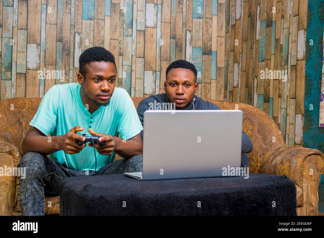 jeunes hommes noirs jouant à un jeu vidéo sur un ordinateur portable à la maison Banque D'Images
