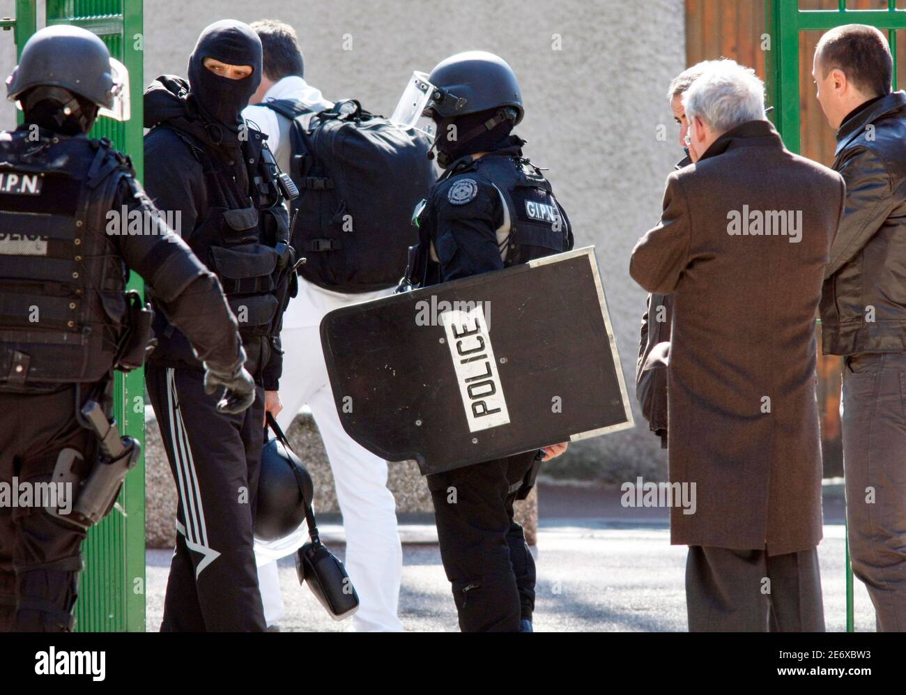 French elite GIPN unit police inspect the neighbourhood after women have  been slightly injured by gunman in a public garden in Lyon March 20, 2009.  A man fired a small air gun