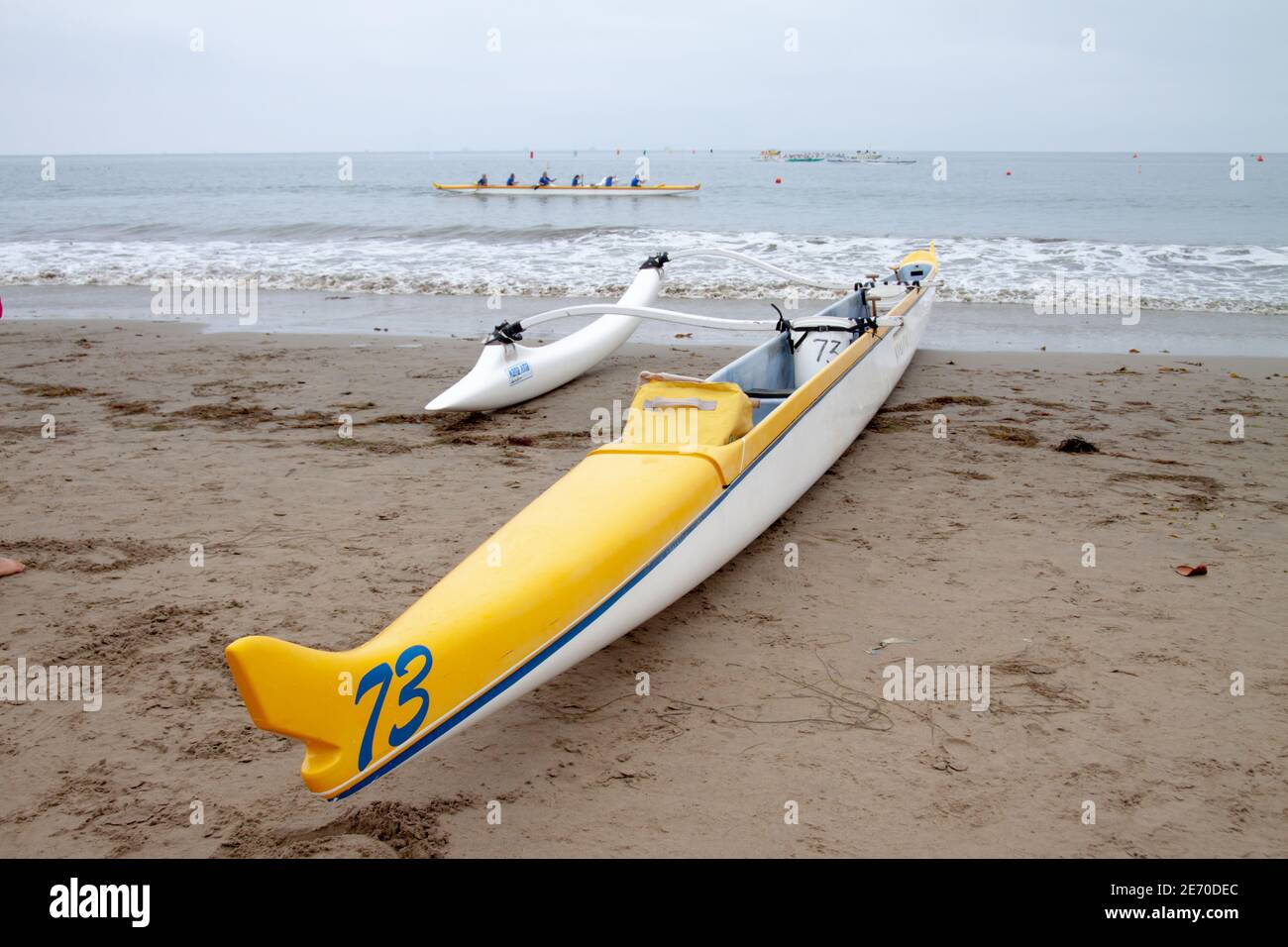 Canoë-kayak jaune et blanc sur une plage de sable Banque D'Images