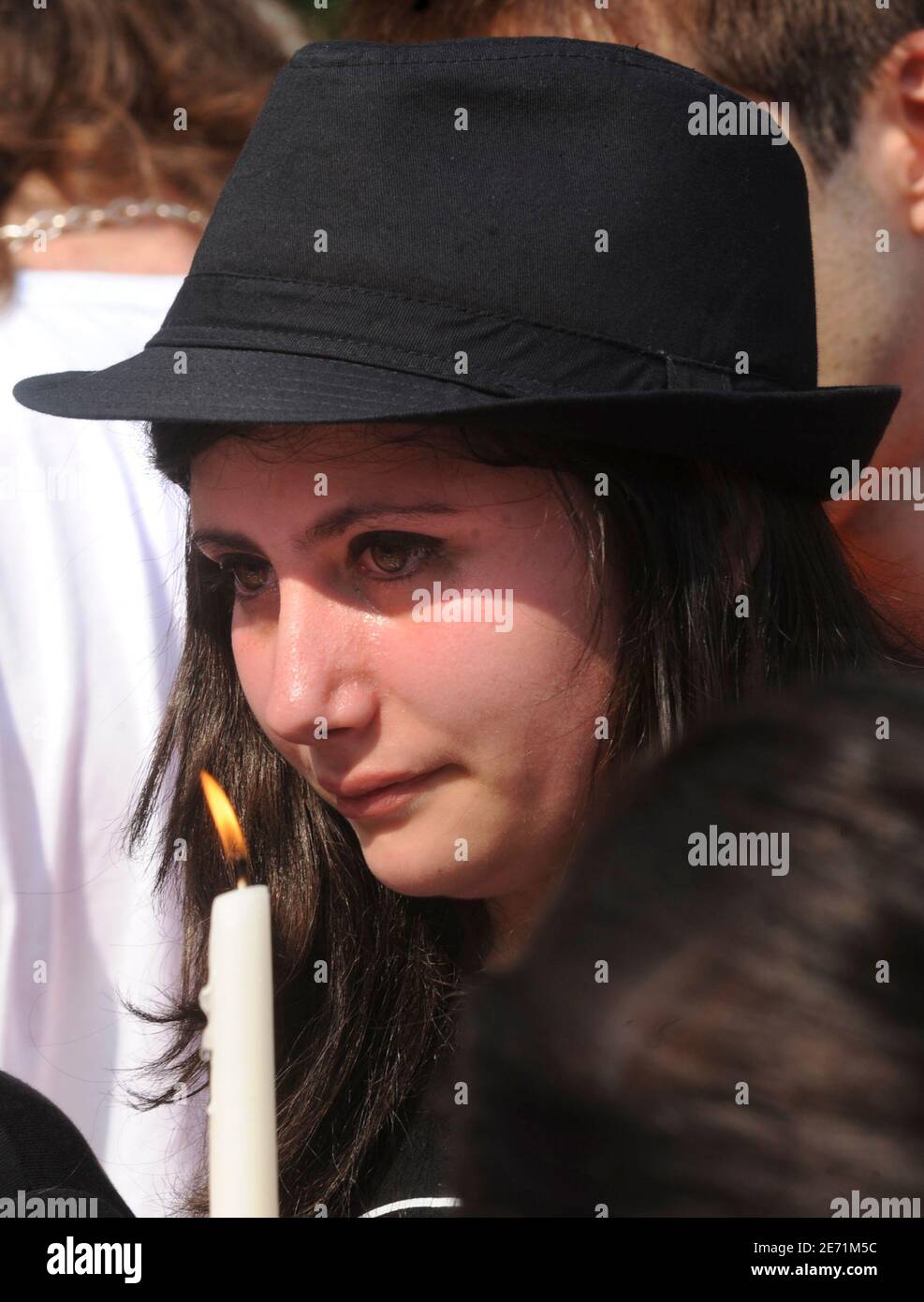A woman cries during a memorial by Italian fans of late pop singer Michael  Jackson in Milan June 27, 2009. The body of Michael Jackson has been  released to his family, a