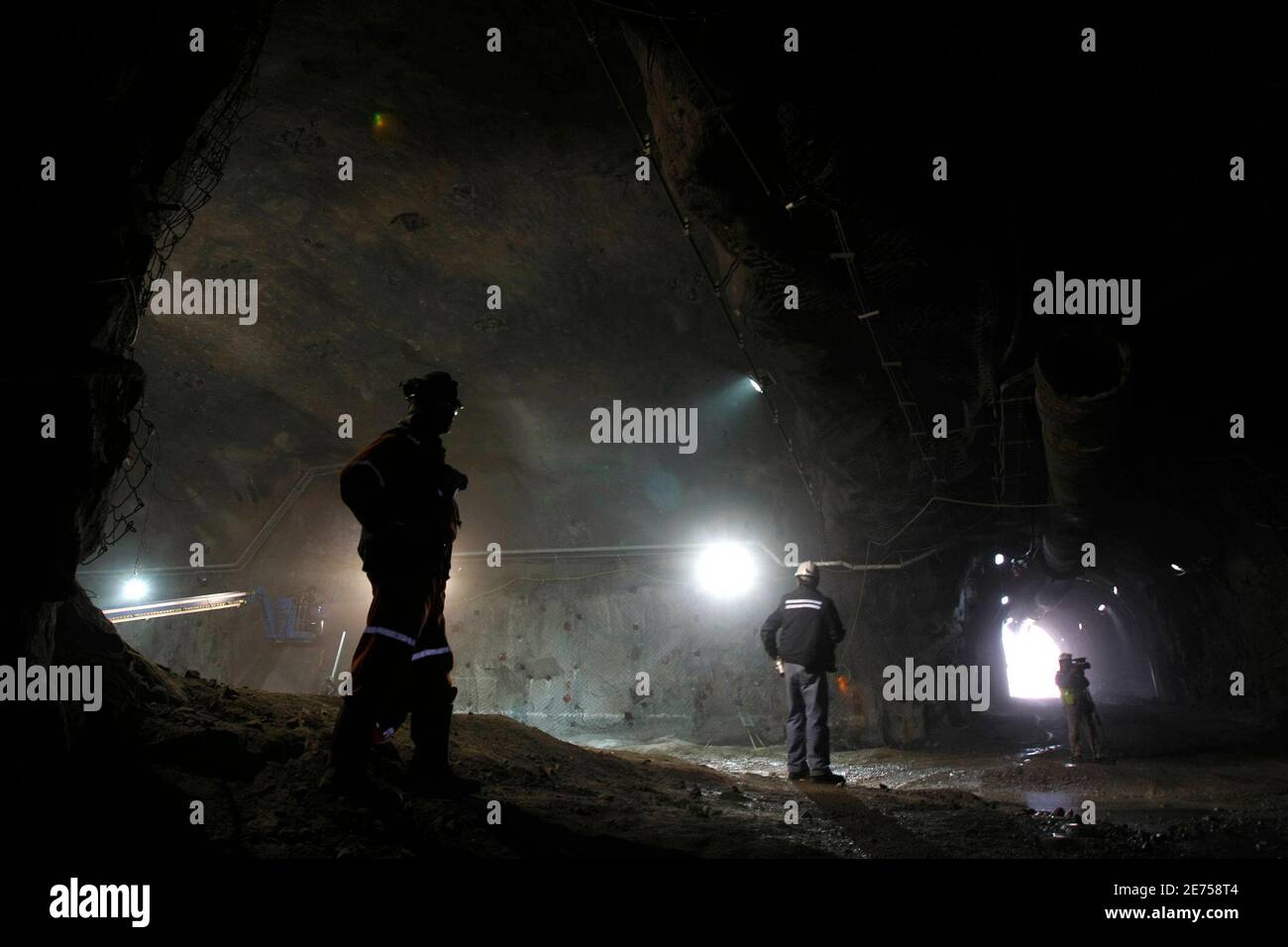 Workers stand in the Andina copper mine, 49 miles (80 km) north east of  Santiago March 25, 2009. Deep inside the Andes mountains at some 3,800  meters (12,500 feet) above sea level,