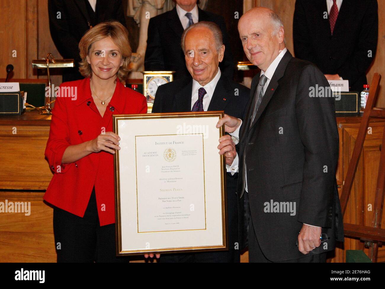 Israel's President Shimon Peres (C) stands between Valerie Pecresse (L),  French Minister for Higher Education and Research and Jean-Francois Bach,  Perpetual Secretary of the Academy of Sciences as he receives a Honour