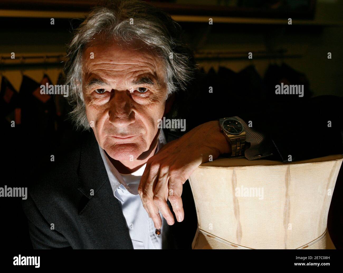 British designer Paul Smith poses for a photo in his office in central  London February 17, 2009. As the world falls deeper into a recession,  British fashion powerhouse Sir Paul Smith talked