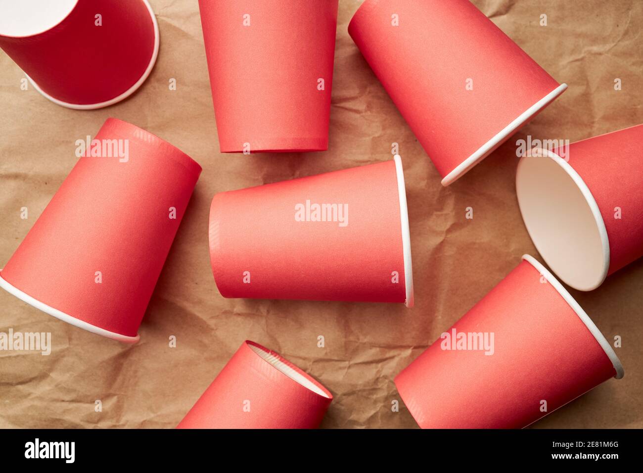 pile de gobelets jetables en papier rouge sur fond de papier. concept écologique. regardez d'en haut. toile de fond Banque D'Images