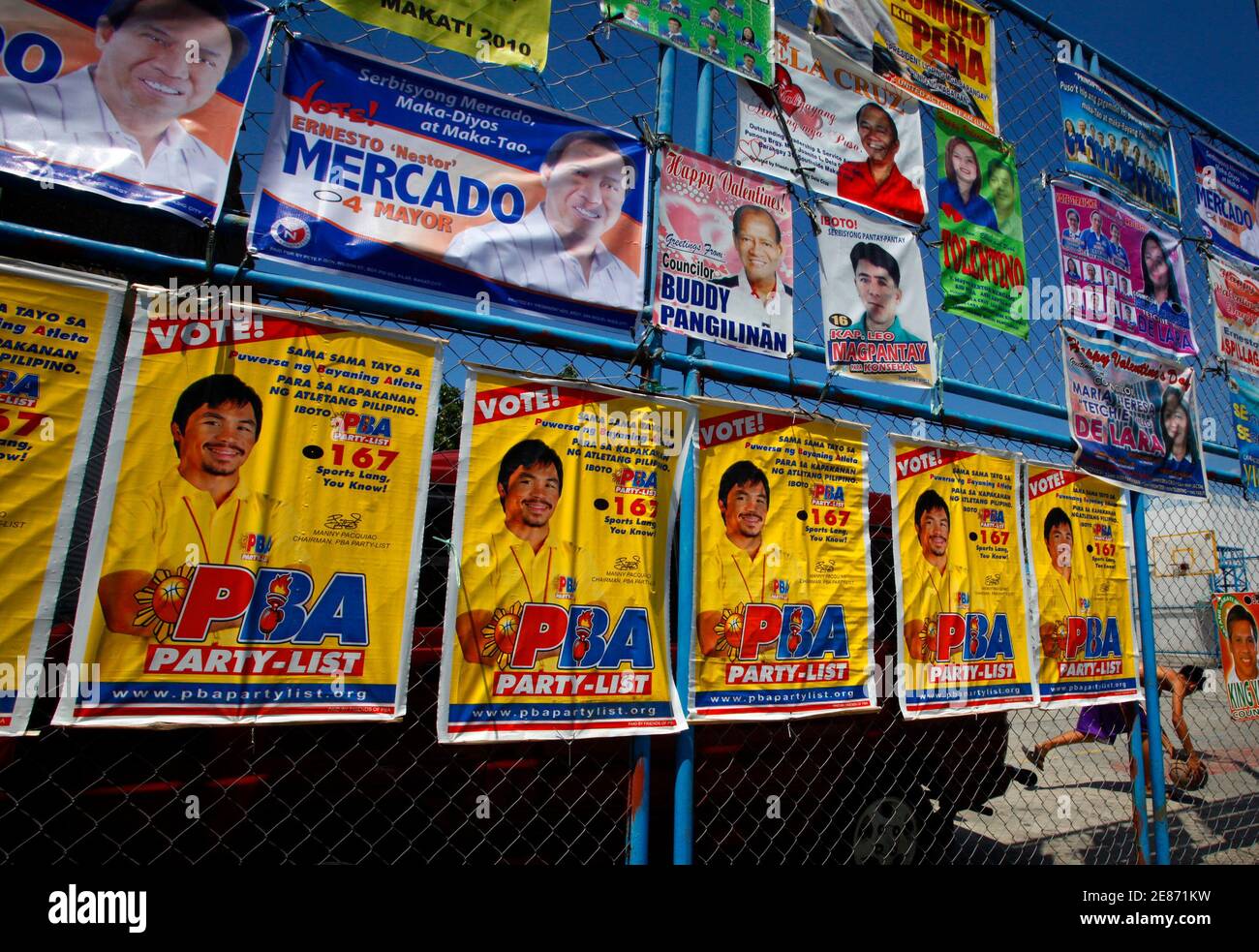 Election campaign posters featuring world boxing champion Manny Pacquiao  (bottom row) are pictured on a fence in Manila May 6, 2010. The Philippines'  automated voting system could throw up some problems in