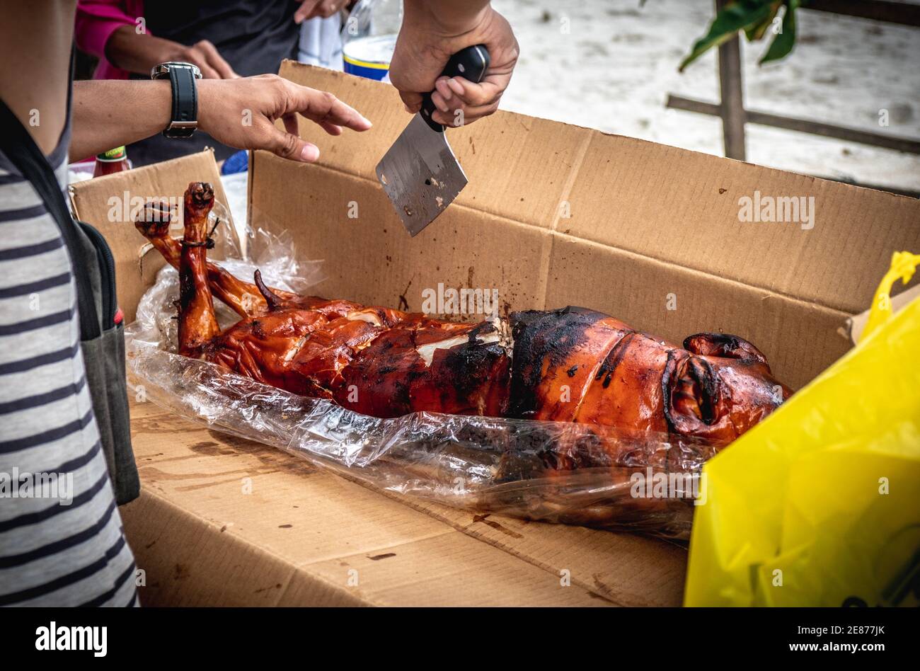 Sur le point de manger le délicieux Lechon (rôti de porc) pendant les vacances à Davao City Philippines. Merveilleux séjour sur la plage. Hacher des aliments à manger. Banque D'Images