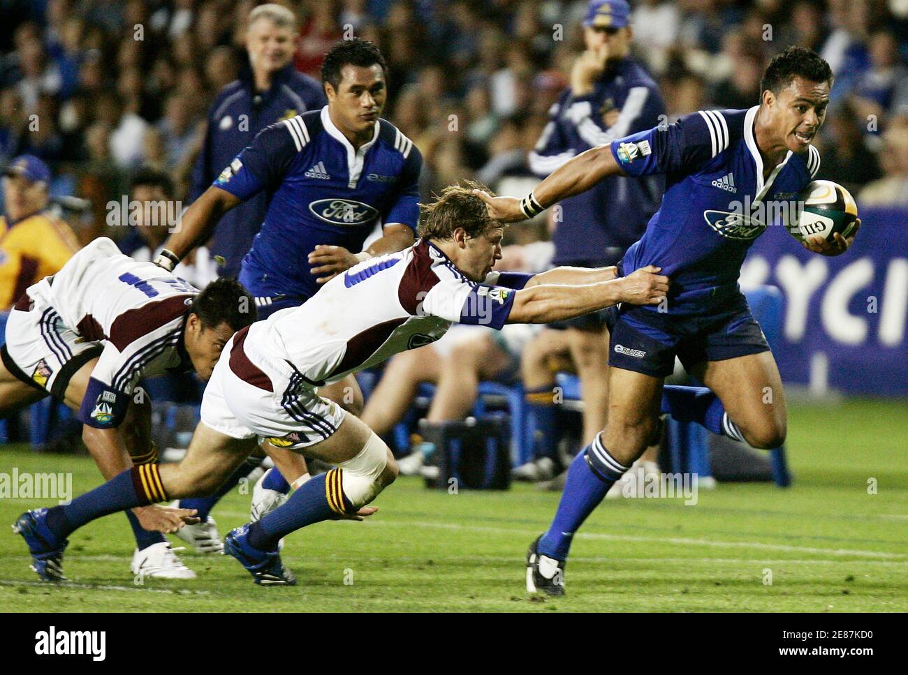 Rudi Wulf of Auckland Blues runs through the tackle of Nick Evans of Otago  Highlanders during their Super 14 rugby union match at Eden Park in  Auckland March 2, 2007. REUTERS/Nigel Marple (