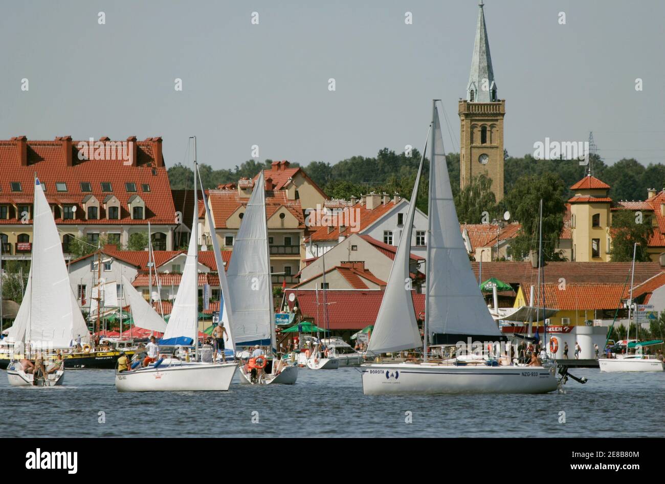People sail along Mikolajskie Lake, near the town of Mikolajki in Masurian  Lake District, north eastern Poland August 20, 2009. The lake district,  which was shaped by the Pleistocene ice age, contains