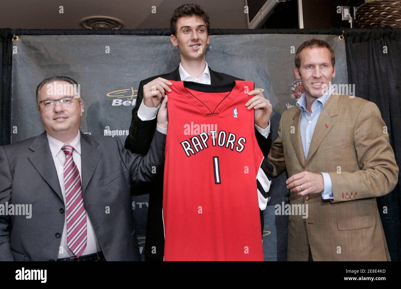 Toronto Raptors first overall draft choice Andrea Bargnani (C) holds his  team jersey with Raptors President and General Manager Bryan Colangelo (R)  and vice president and vice general manager Maurizio Gherardini at