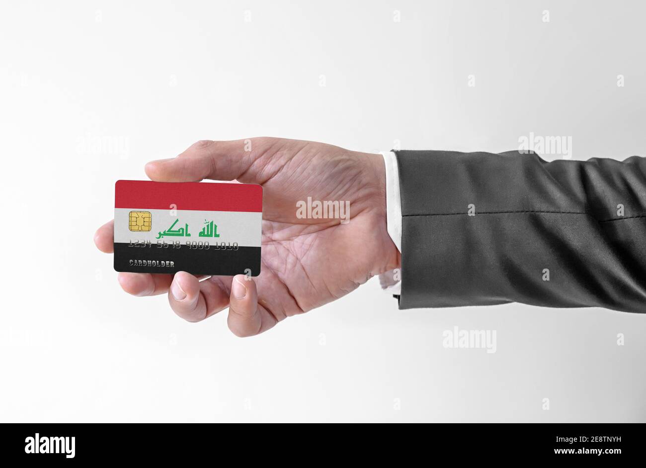 Carte de crédit bancaire en plastique avec drapeau de l'homme de holding de l'Irak en costume élégant Banque D'Images