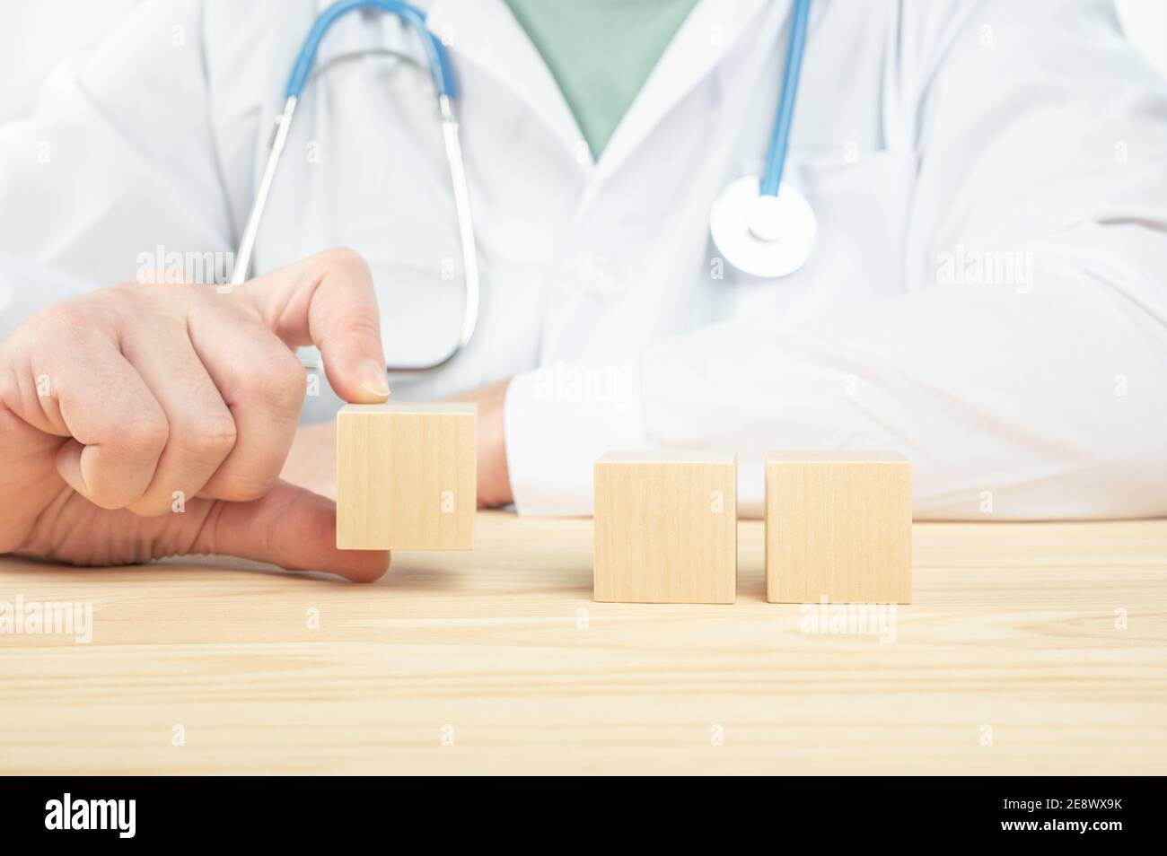 le médecin présente des cubes de bois vierges avec un espace vide pour votre texte. le médecin recommande de prendre. le médecin parle des avantages. concept médical Banque D'Images