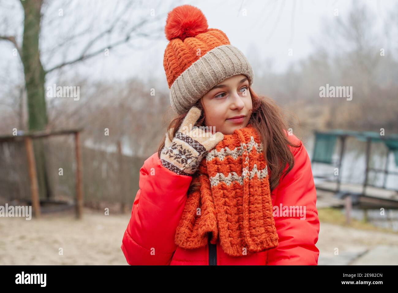 Fille De 10 Ans. Fille En Veste Orange, Bonnet Et Écharpe. Fille