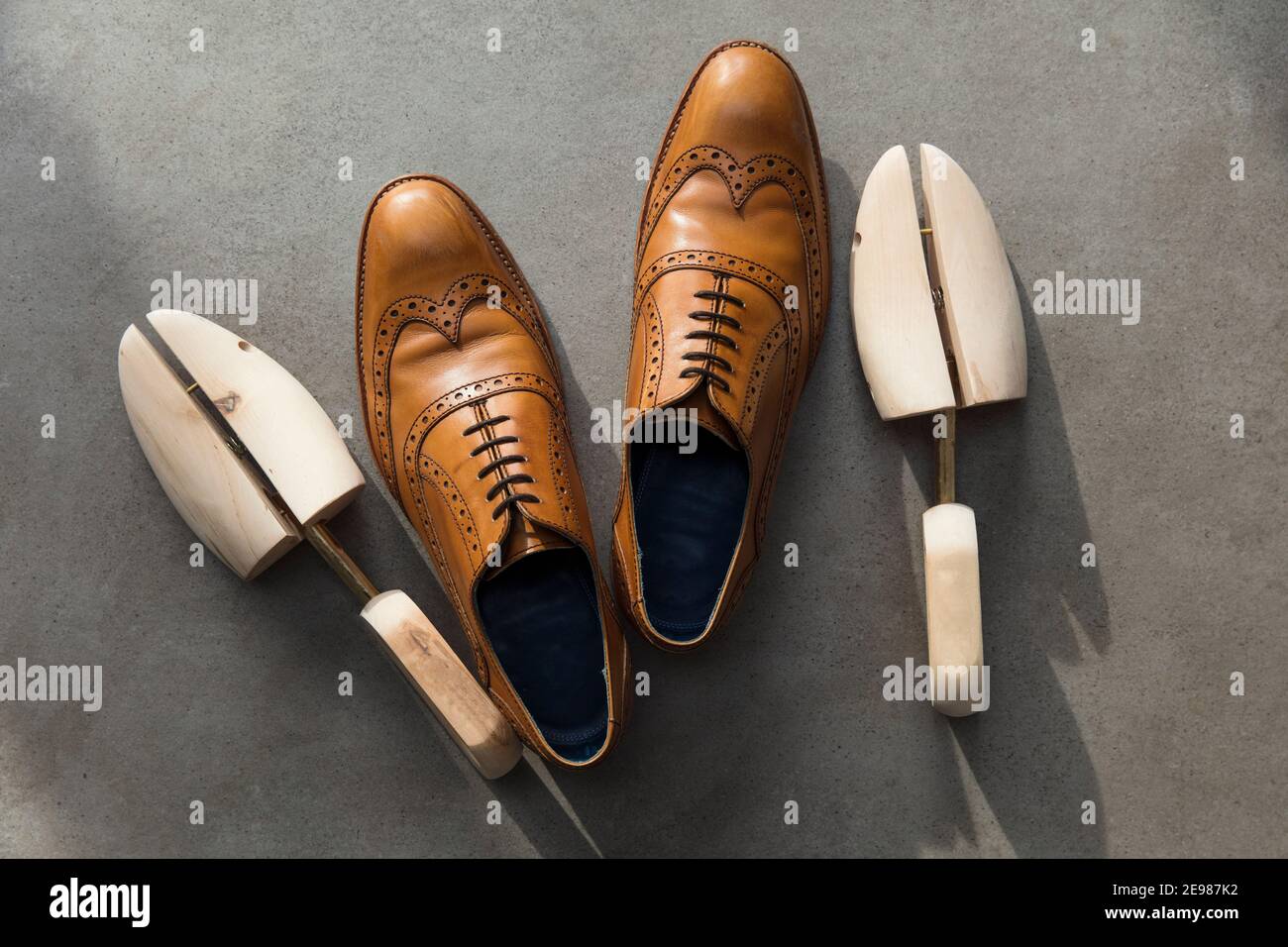 Vue en hauteur d'une paire de hommes en cuir brun clair chaussures habillées sur béton Banque D'Images