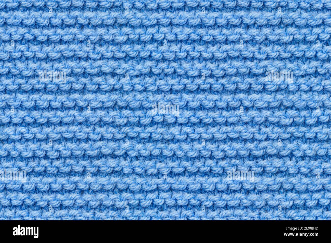 Tissu bleu tricots texture. Instantané de macro de texture de couture machine. Arrière-plan en maille bleue. Banque D'Images