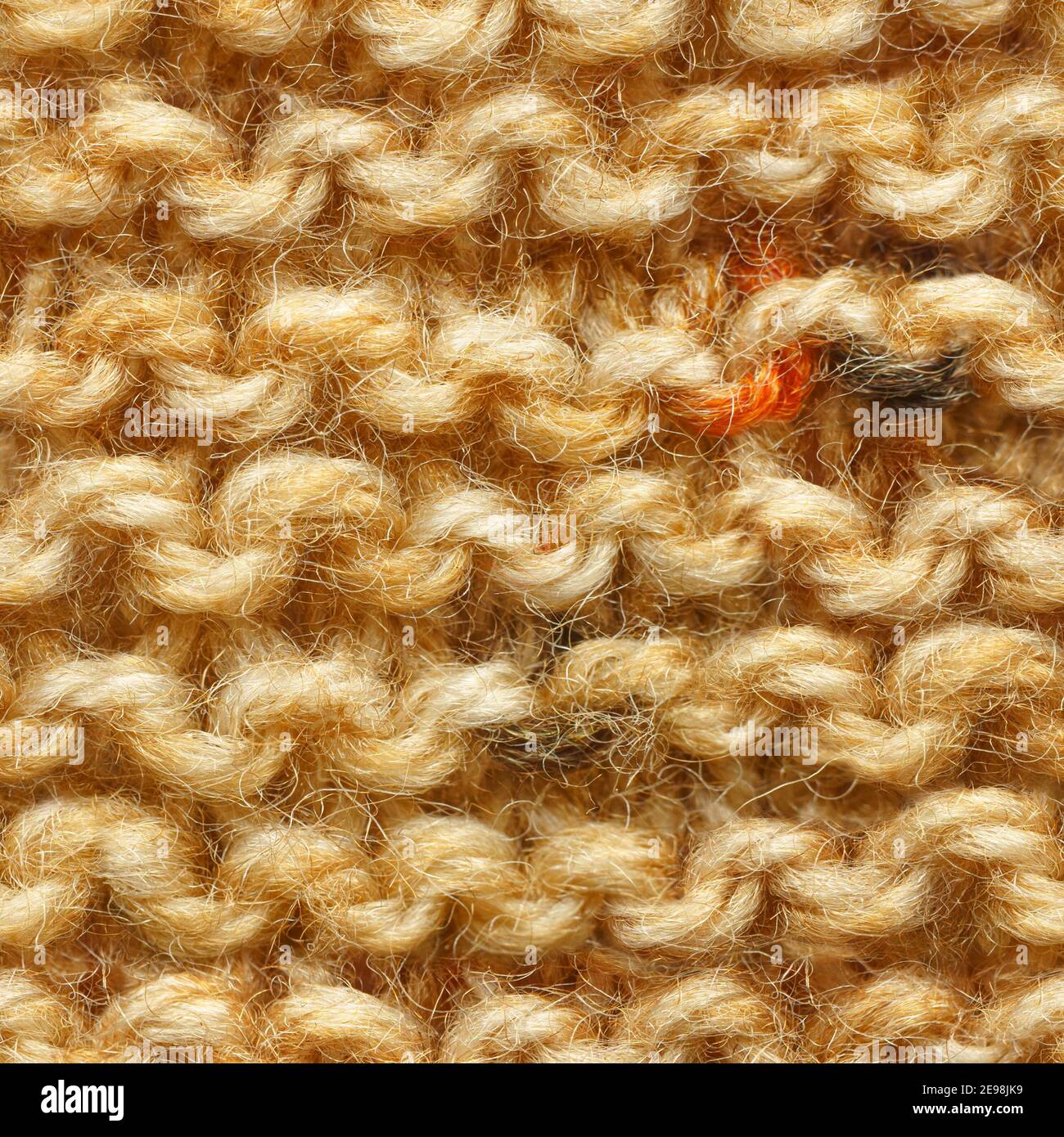 Tissu tricoté marron jaune beige motif sans couture pour un garnissage sans bordure. Tissu tricoté à motif répétitif pour un gros plan sur l'arrière-plan. Banque D'Images
