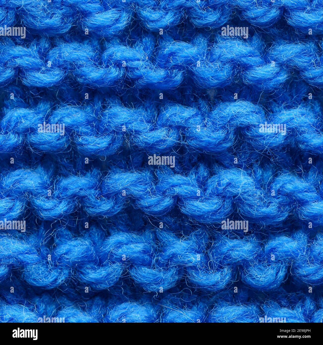 Tissu tricoté bleu foncé sans coutures pour un garnissage sans bordure. Tissu tricoté à motif répétitif pour un gros plan sur l'arrière-plan. Banque D'Images