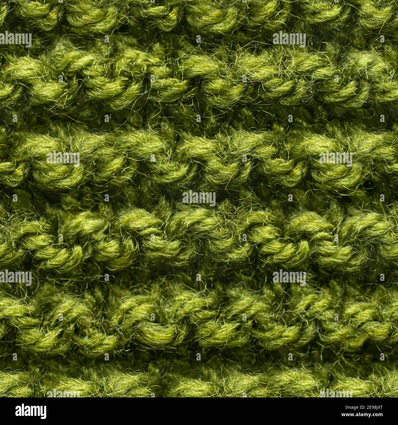 Tissu tricoté vert sans couture pour un garnissage sans bordure. Tissu tricoté à motif répétitif pour un gros plan sur l'arrière-plan. Banque D'Images