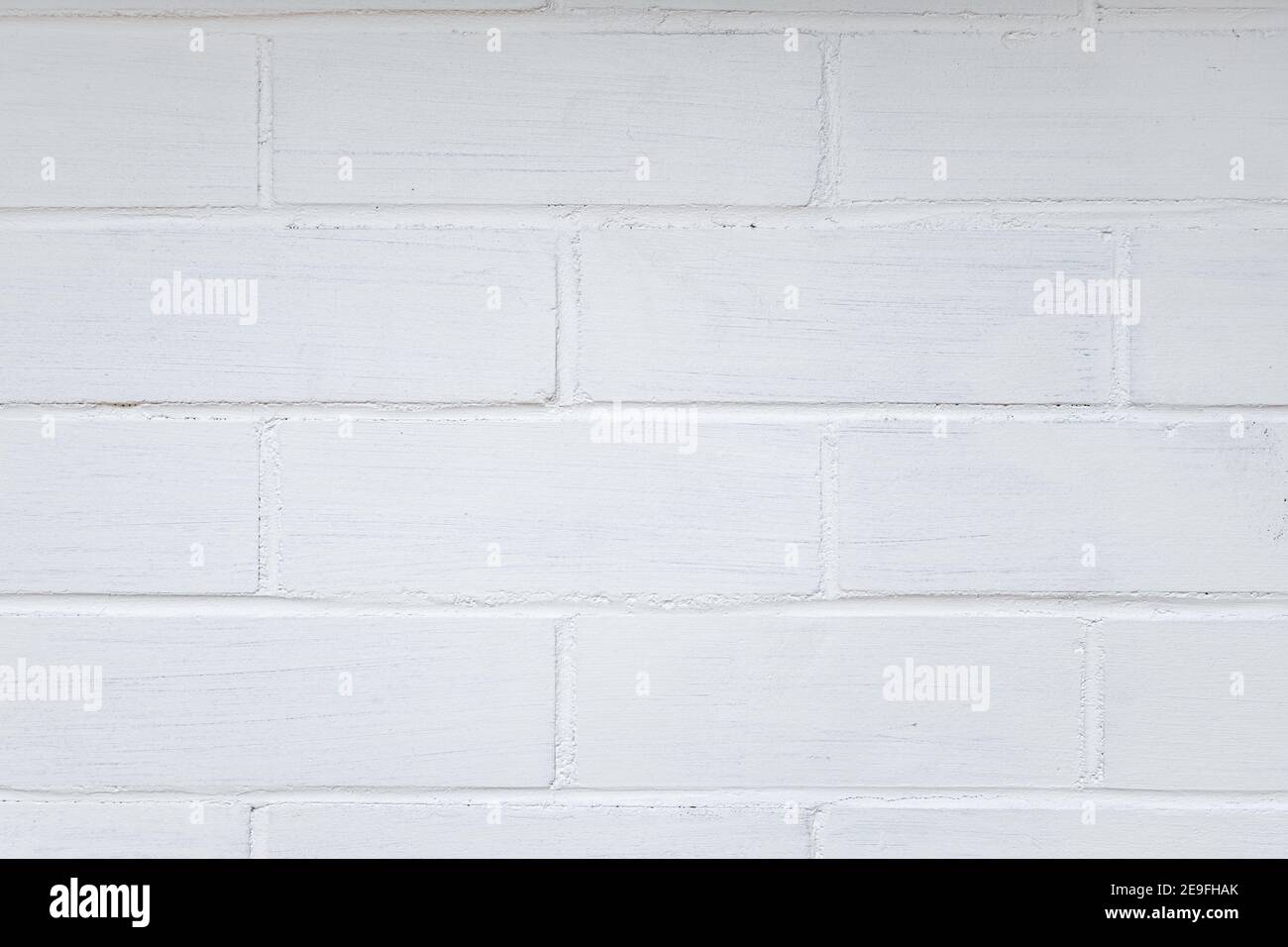 Photographie d'un mur de briques peint en blanc Banque D'Images