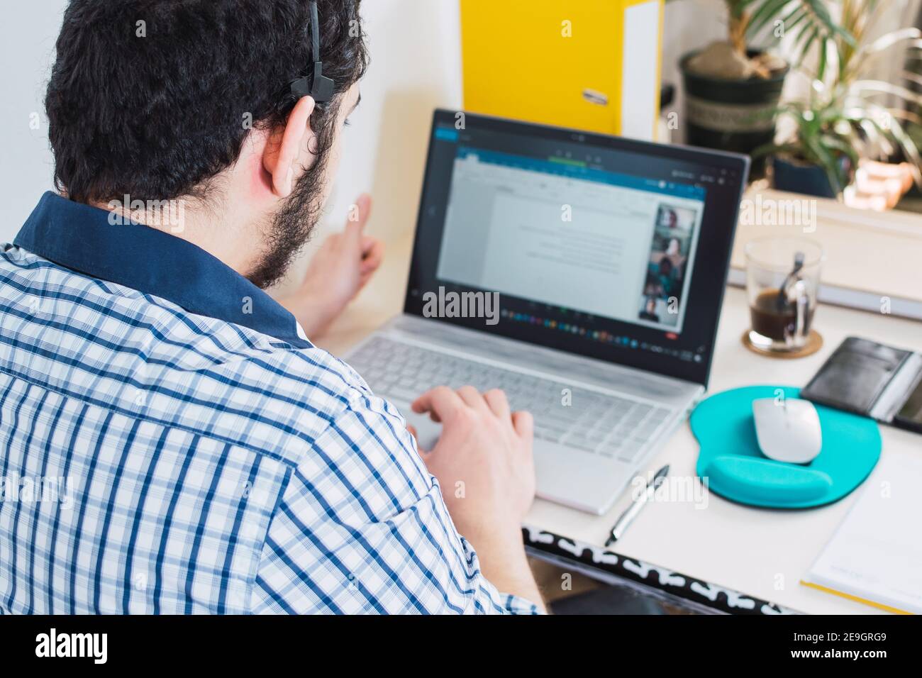 Homme dans un appel vidéo de groupe pendant son travail à domicile pendant la quarantaine Banque D'Images