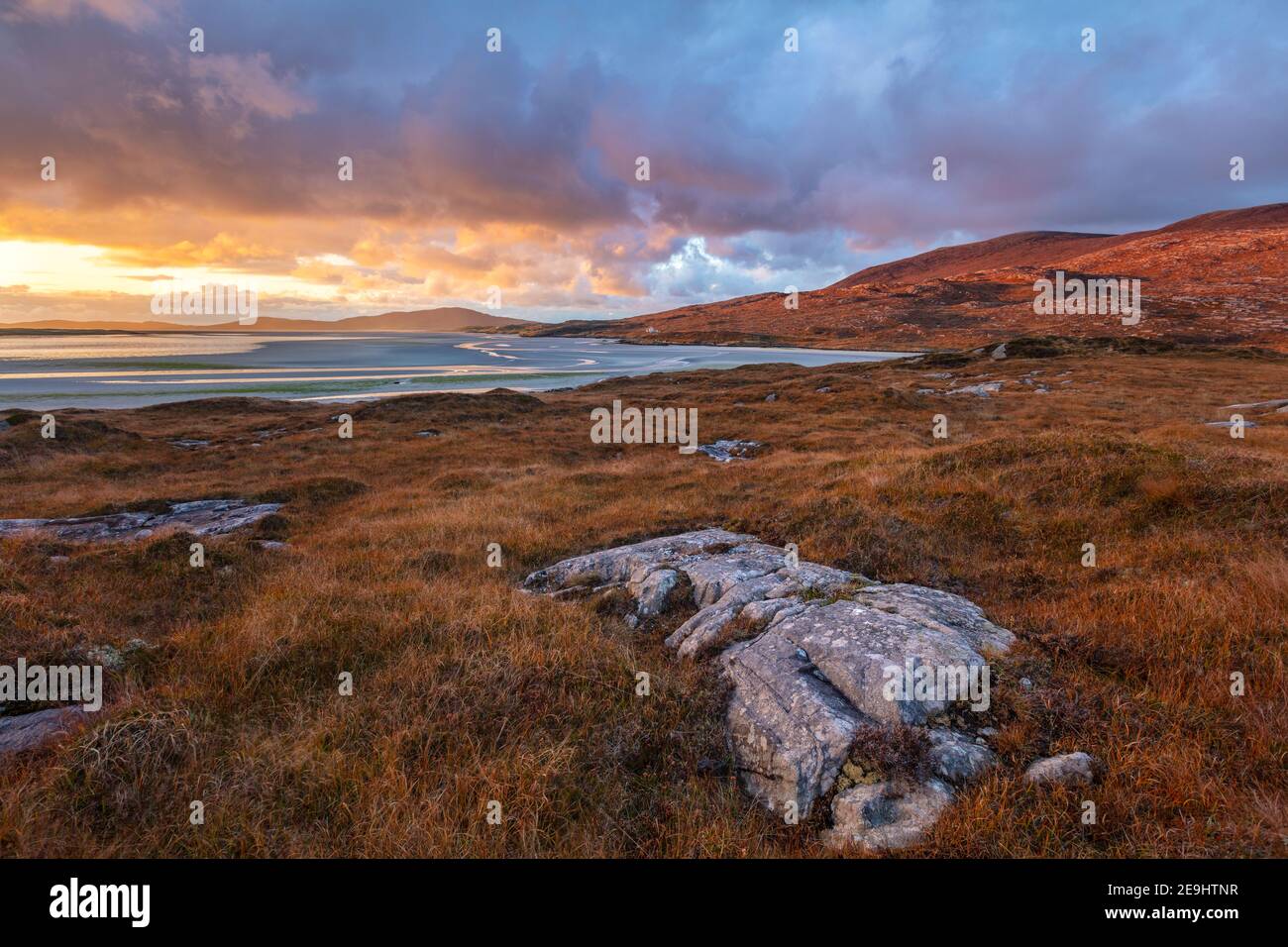 Île de Lewis et Harris, Écosse: Rochers dans le machair avec la large étendue de la plage de LUSKENTIRE au coucher du soleil sur l'île de Harris Banque D'Images