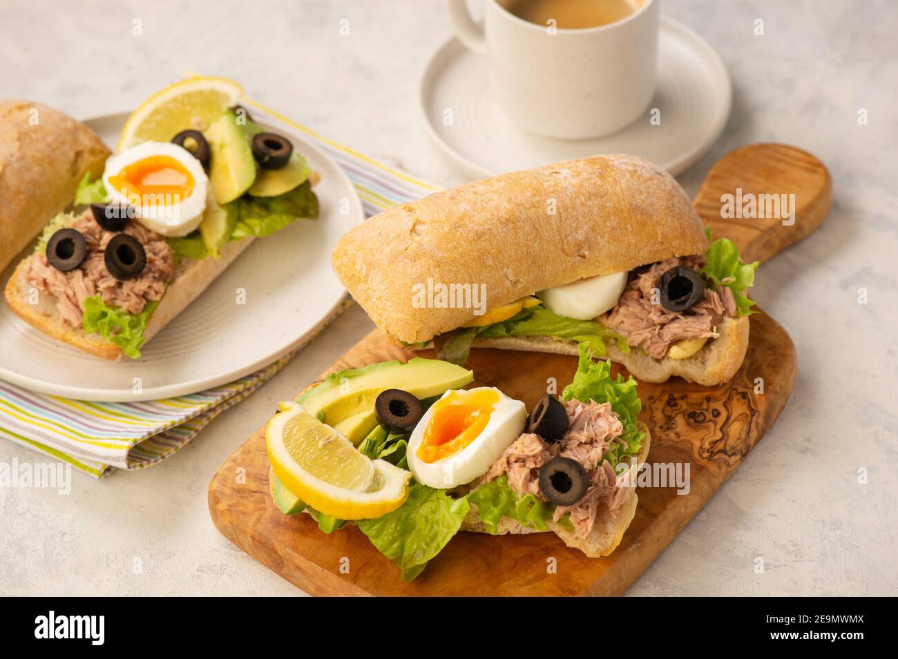 Sandwichs au thon, aux œufs, aux olives et à l'avocat sur fond clair. Banque D'Images