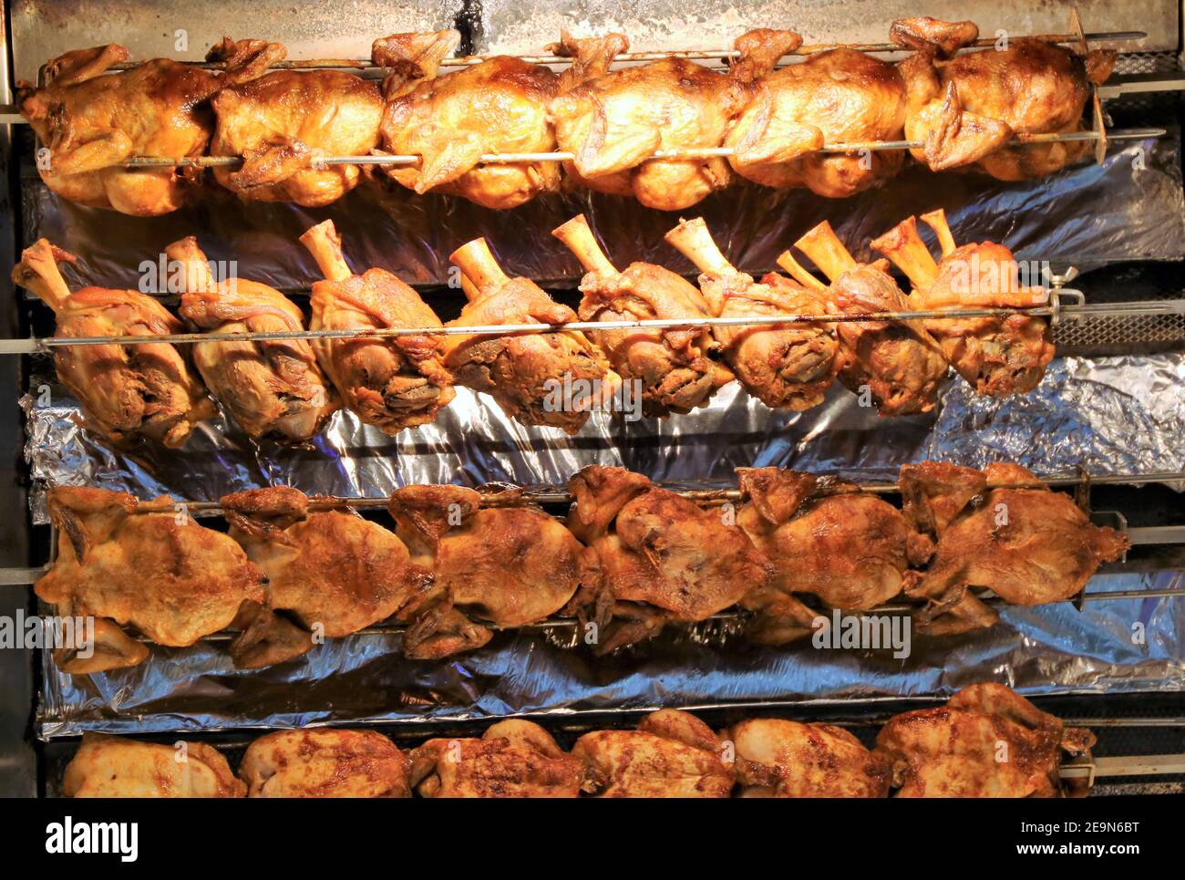 Jarret de porc grillé (branche de porc rôtie) et faites rôtir le poulet sur la  broche rotative Photo Stock - Alamy