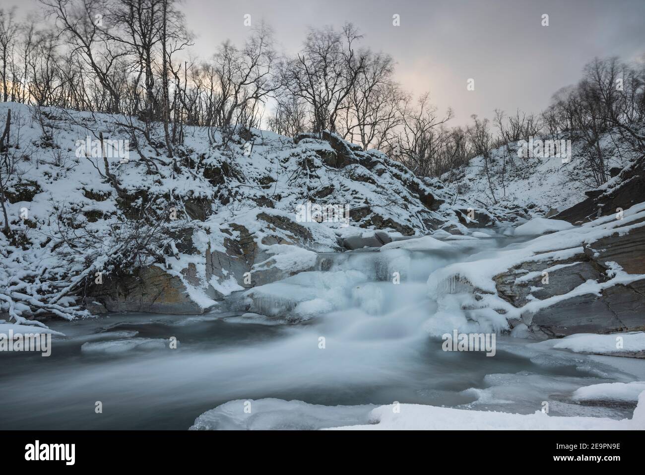 cascade glacée dans la neige à long expo Banque D'Images