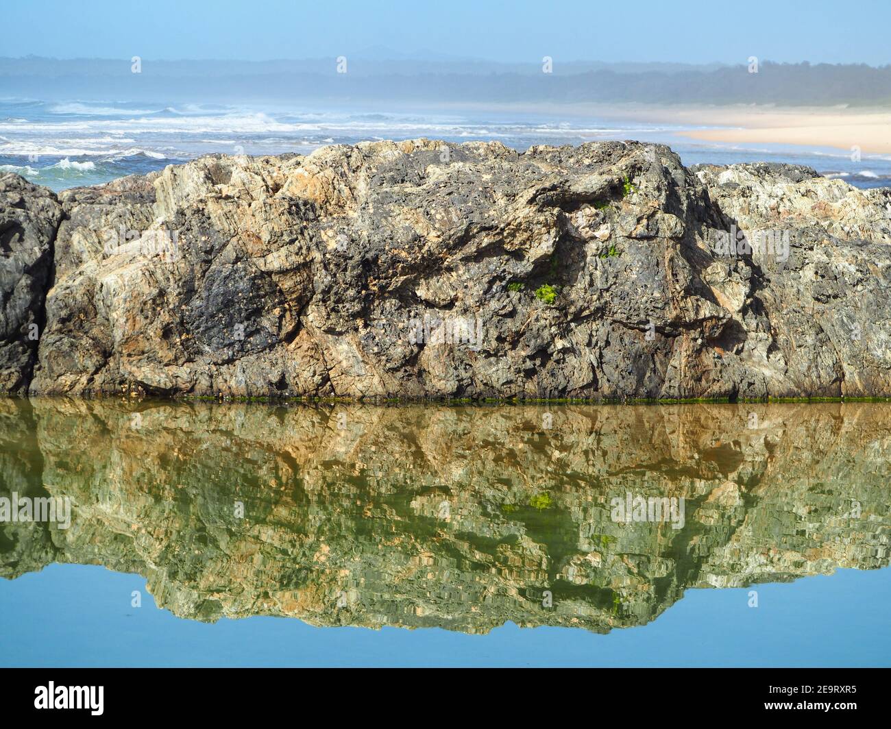 De magnifiques reflets. Les rochers bordant la piscine se réfléchit et se reflétaient dans l'eau salée, en regardant au-delà de l'océan Pacifique Banque D'Images